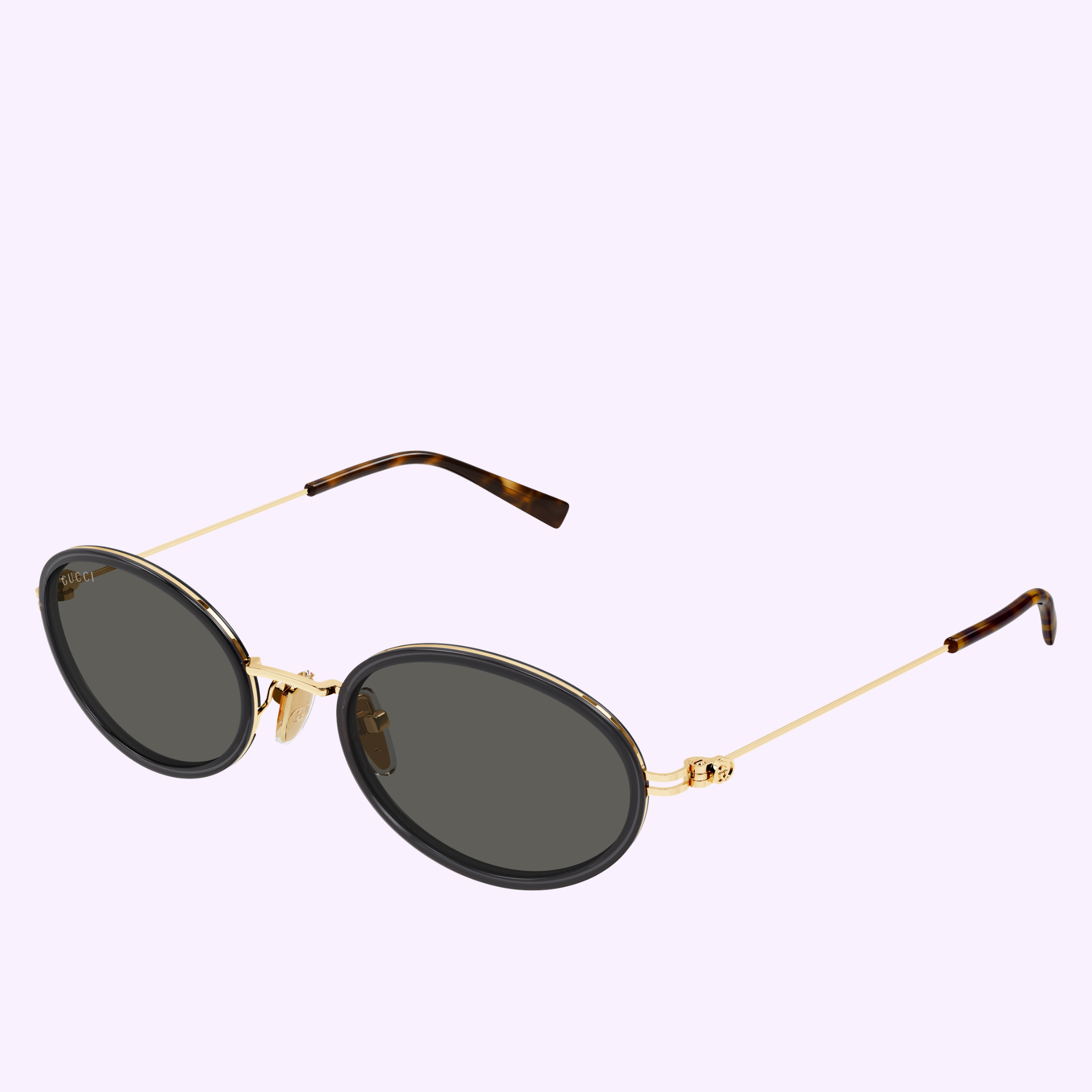 The Gucci Sunglasses GG1980S-001 52 feature oval dark lenses, thin gold metal arms, and tortoiseshell-patterned tips—ideal for luxury eyewear lovers—shown here on a light purple background.