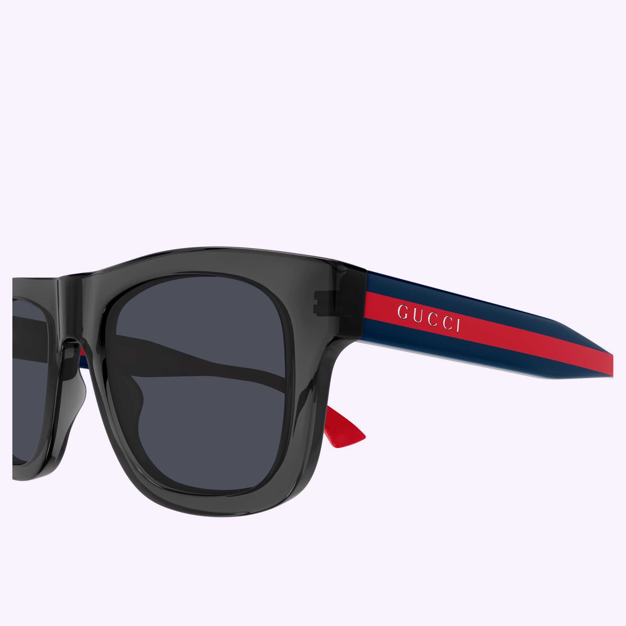 Close-up of Gucci Sunglasses GG1991S-004 52 featuring dark lenses, blue and red striped arms, and the Gucci logo in white—an iconic accessory from Gucci Sunglasses on a light pastel background.