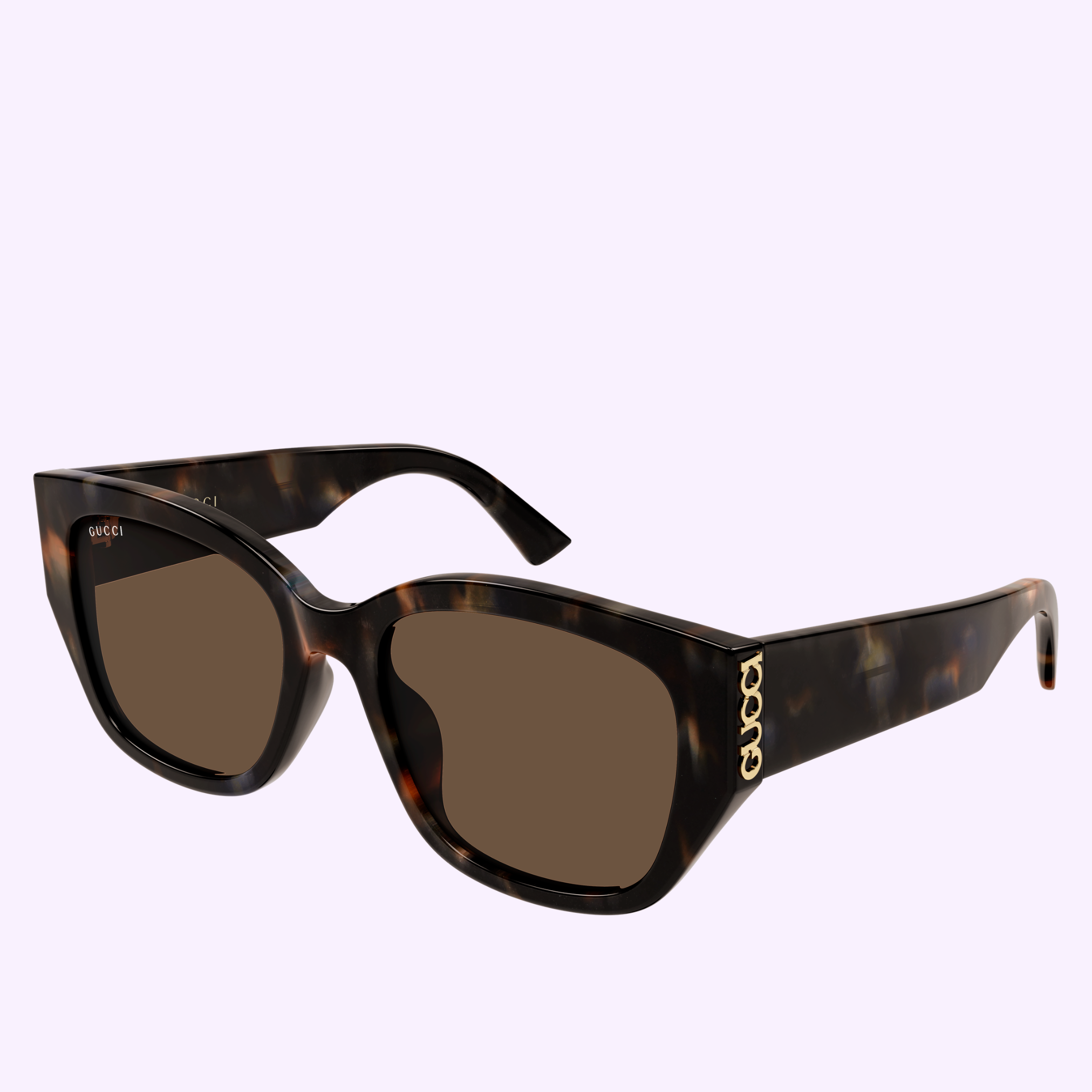The Gucci Sunglasses GG2043SA-003 55 feature thick tortoiseshell frames and brown lenses, adorned with gold GUCCI lettering on the temples to embody true luxury fashion. This model is stylishly showcased against a light purple background.
