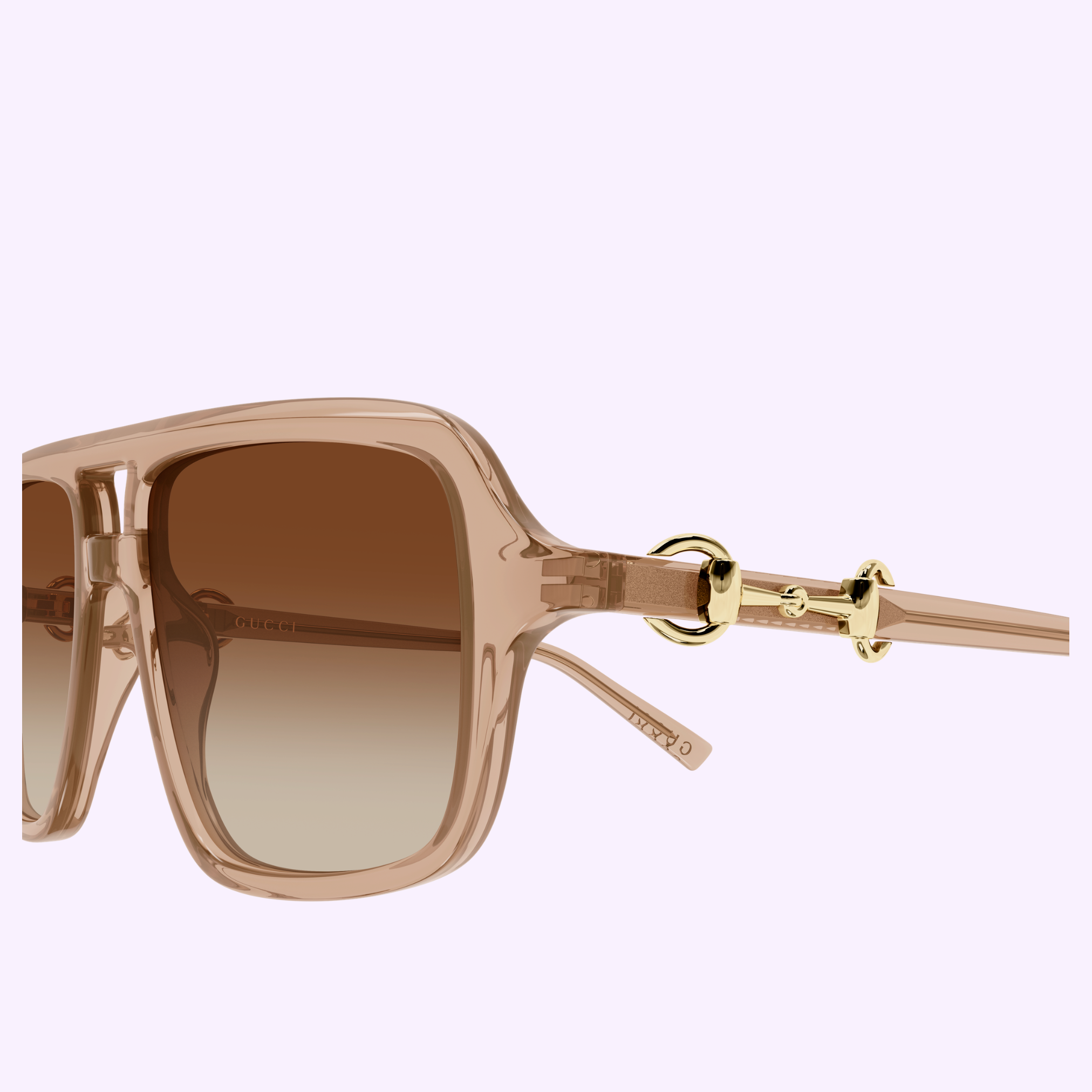 Close-up of the Gucci Sunglasses GG2052S-010 55 by Gucci Sunglasses, featuring stylish oversized square frames in transparent brown, brown gradient lenses, and elegant gold accents on the temples—an exquisite statement piece for luxury fashion lovers—displayed against a light purple background.