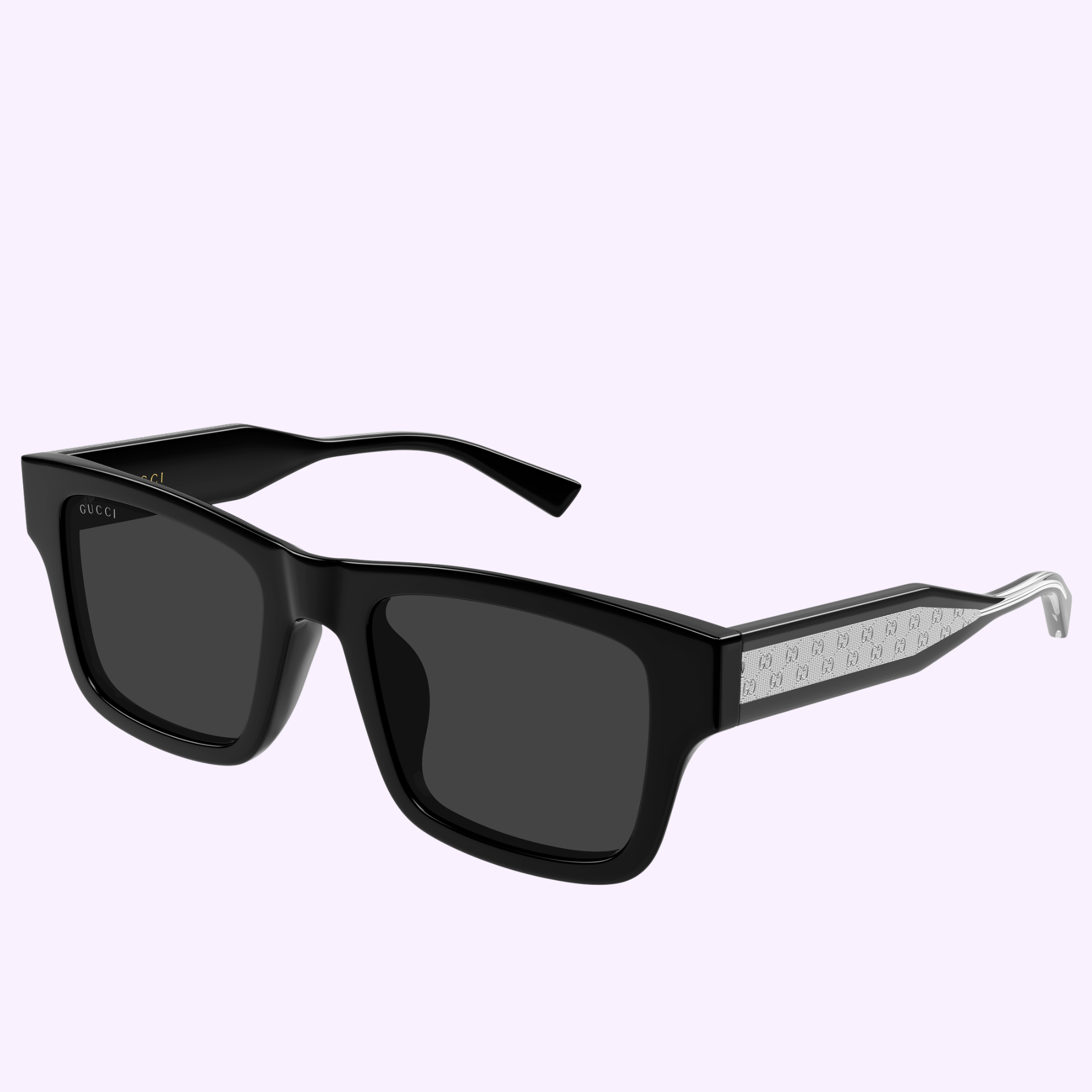 The Gucci Sunglasses GG2072SA-001 52 feature black square frames, dark lenses, and patterned silver arm detailing, shown on a light purple background—ideal for fans of contemporary fashion and sleek style.
