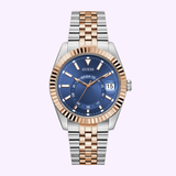 The Guess GW0977G5 Men's Jaden Gold Tone Watch features a blue dial with multi-function date at 3 o’clock, gold hour markers, and a striped metal band alternating gold and silver links for a stylish look. Brand: Guess Watches.