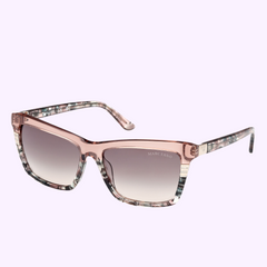 Guess By Marciano Sunglasses GM00010 5753P feature pink translucent square frames, gradient lenses, and marbled arms for a Miami-inspired look. Displayed on a light lavender background. Shop confidently from an Authorized Dealer.