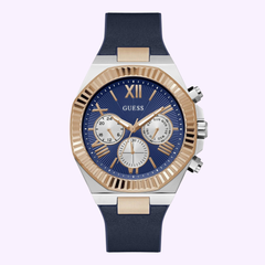 The Guess Watches Mens Blue 2-Tone Multi-function GW0791G2 features a blue face, gold bezel, three subdials, blue strap, silver and gold accents, Roman numeral and baton markers, plus a comfortable Flex Strap.