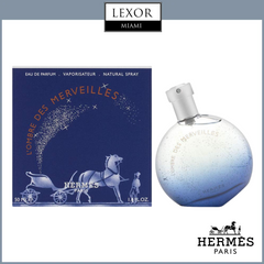 A HERMES L'OMBRE EAU MERVEL 1.7 EDP M + MINI (TRAVEL SET) bottle from Hermes Perfumes sits beside its blue box with a white carriage and gold text, with LEXOR MIAMI and HERMÈS PARIS logos above and below.