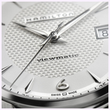 Close-up of the Hamilton Jazzmaster Viewmatic Auto 40 mm Men Watch H32515555 by Hamilton Watches, featuring a silver textured dial with the “viewmatic” inscription, a date window, and “Swiss Made” text near the 6 o’clock position. The stainless steel hour markers and hands are clearly visible on this automatic men’s watch.