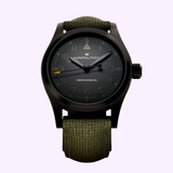 Showcasing the Hamilton Watches Call of Duty: Modern Warfare 4 KHAKI FIELD H69469930 SPECIAL EDITION, this wristwatch by Hamilton Watches features a dark dial with luminescent hands, a black case, and a textured green strap, displayed against a light background. Inspired by the legendary game franchise Call of Duty: Modern Warfare 4, this special edition timepiece is an exceptional choice for collectors and fans alike.