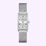 The Hamilton Watches H11221150 American Classic Ardmore Quartz features a rectangular silver case, mesh strap, Roman numeral markers, and a small subdial above 6 o'clock, shown on a light purple background.