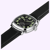 Hamilton American Classic Cushion Mechanical H36129730 watch featuring a black dial, glowing green Arabic numerals, and a black leather strap.