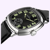 Hamilton American Classic Cushion Mechanical H36129730 watch with a cushion-shaped case, a black dial featuring large luminous numerals, and a black leather strap.