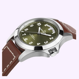 Hamilton Watches H64475560 Khaki Field King Day-Date analog watch with a green dial, silver-tone case, and brown leather strap, featuring a day-date window at the 12 o’clock position.