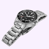 The Hamilton Watches H82415130 Khaki Navy Scuba Auto 40mm is a stainless steel automatic dive watch with a black bezel and dial, silver hour markers, and a metal link bracelet from Hamilton Watches, shown on a light purple background.