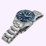 A Hamilton Watches H82425140 Khaki Navy Scuba Auto 40 mm—featuring a silver stainless steel bracelet, blue dial, white hour markers, and rotating bezel—is showcased at an angle against a light background, capturing the sophisticated look of this renowned Hamilton Watches timepiece.