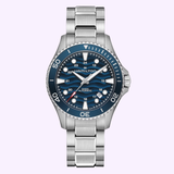 The Hamilton Watches H82425140 Khaki Navy Scuba Auto 40 mm wristwatch by Hamilton Watches features a silver case, blue bezel and dial, silver hour markers, and a metal link bracelet. Displayed against a pale background, this elegant reloj automático exemplifies the renowned craftsmanship of the Hamilton Watches collection.