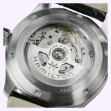 Close-up of the back of the Hamilton Watches Khaki Field Murph 38mm H70405140, featuring its exposed inner mechanical movement, visible gears, and engravings highlighting water resistance, jewel count, Swiss made designation, and branding from Hamilton Watches. Famously recognized as the “interstellar watch.”.