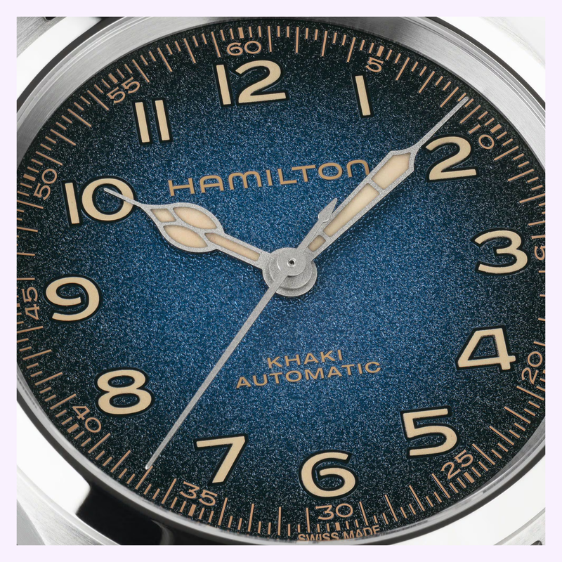 Close-up of the Hamilton Khaki Field Murph 38mm H70405140 dial showing beige Arabic numerals and cathedral hands on the textured blue-to-black dial