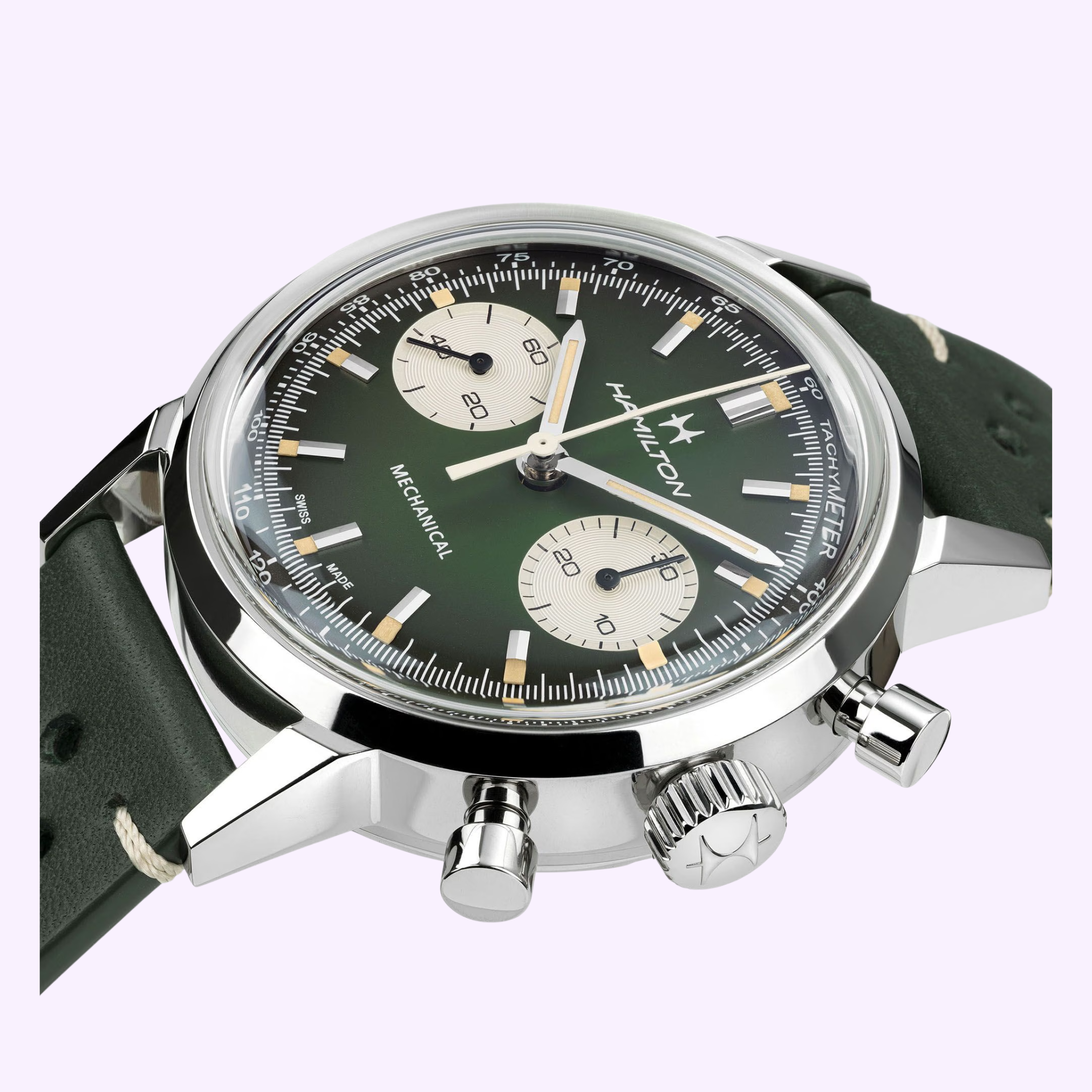 A close-up of the Hamilton Watches American Classic Intra-matic Chronograph H38429861 shows its green dial, cream subdials, silver case, and dark green leather strap. This model features two pushers and a crown on the side.