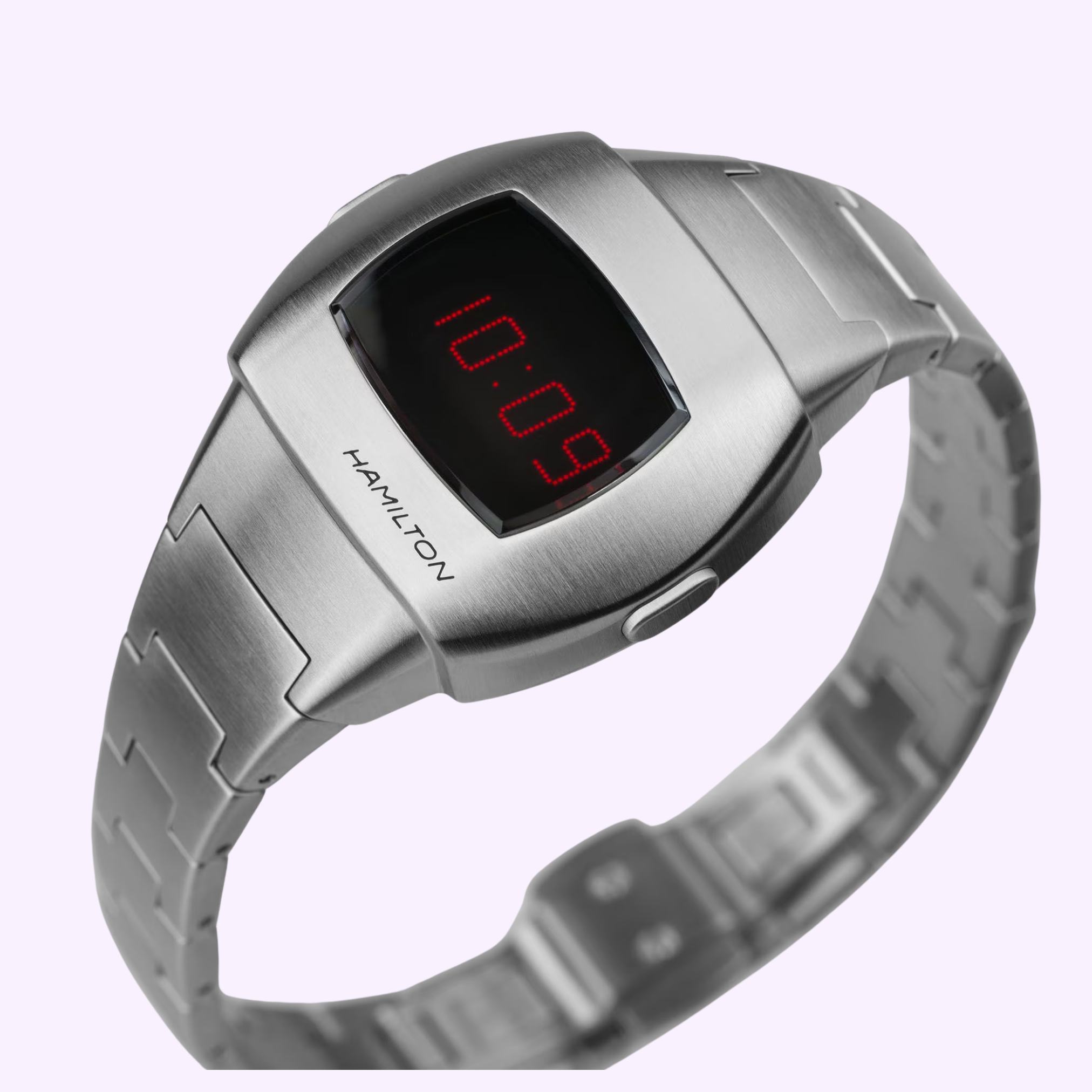 The Hamilton Watches American Classic PSR 74 H52304130 features a silver stainless steel band, a red LED display showing 10:09, and a retro-futuristic design inspired by the vintage cushion Pulsar era.
