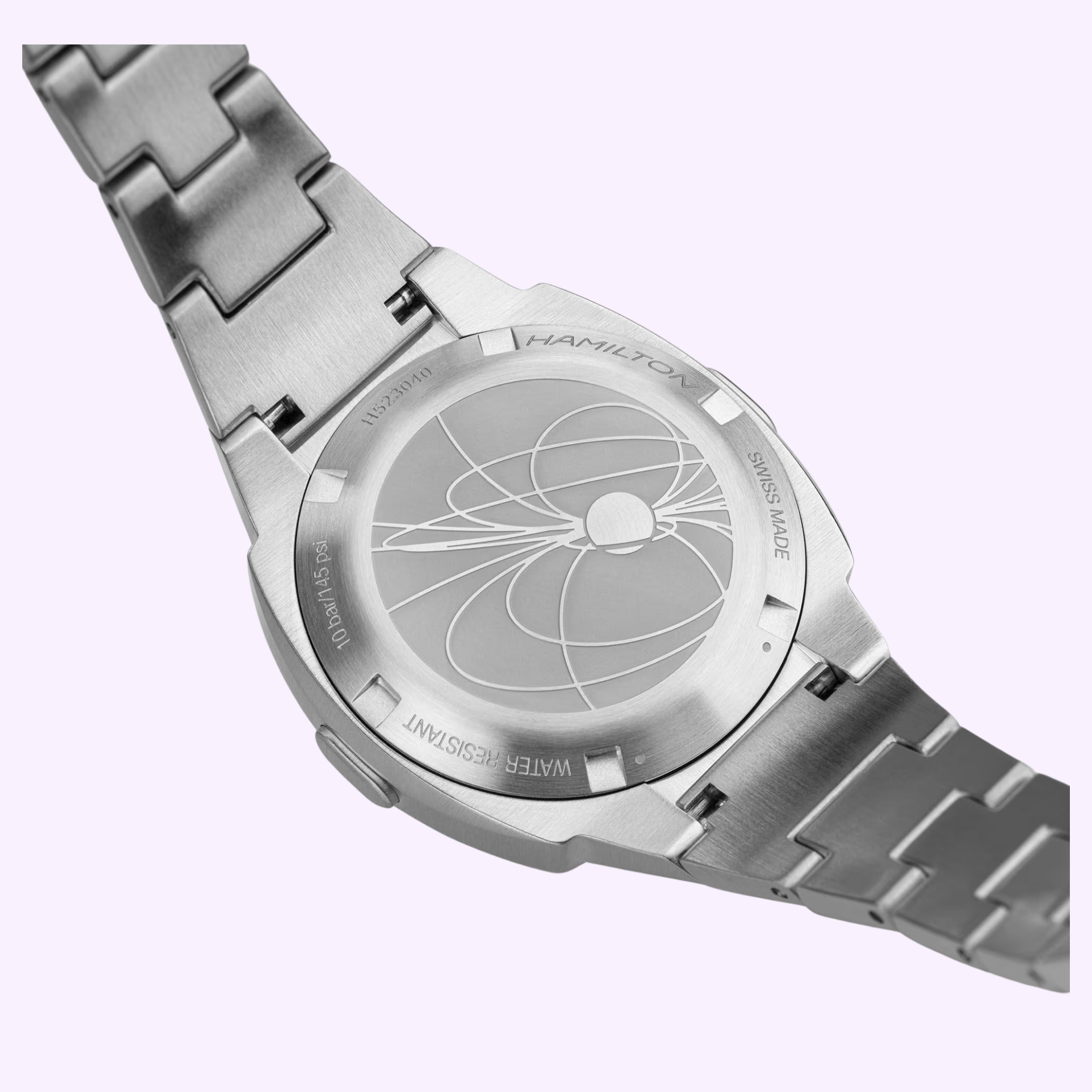 A close-up of the stainless steel Hamilton Watches American Classic PSR 74 H52304130 back shows an engraved geometric design, Swiss Made, Water Resistant text, and a nod to the vintage cushion Pulsar digital watch.