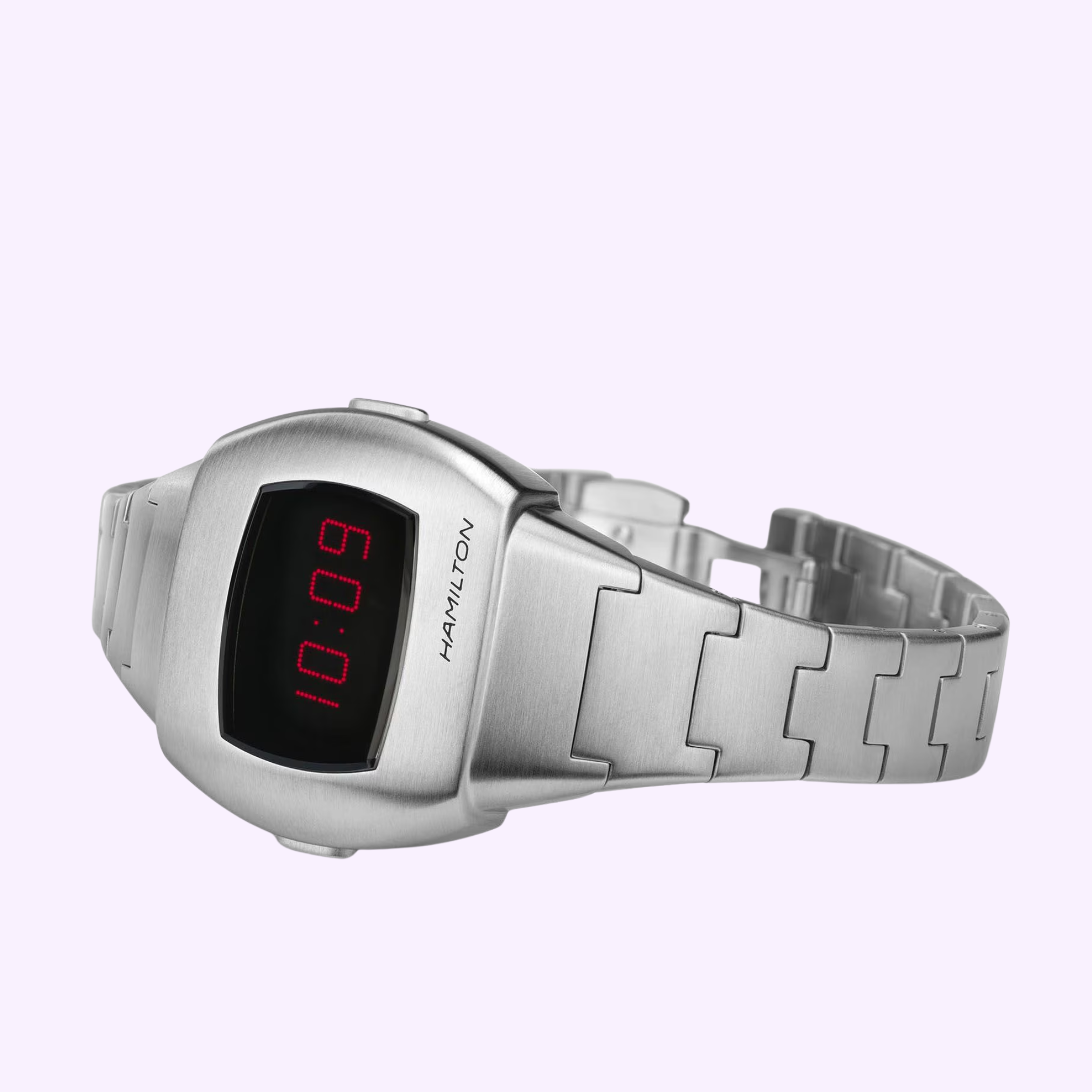 The Hamilton Watches American Classic PSR 74 H52304130 features a brushed stainless steel case and bracelet, vintage cushion pulsar design, and red LED display at 10:09, shown angled on a light purple background.