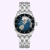 The Hamilton Watches Jazzmaster Open Heart Auto H32675140 features a silver metal bracelet, blue gradient dial, and open-heart design highlighting its automatic mechanical movement.