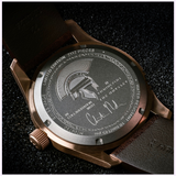 The Hamilton Watches Khaki Field Auto The Odyssey Limited Edition H70675530 features a bronze case back engraved with a Spartan helmet, Hamilton × The Odyssey, Christopher Nolan’s signature, and is limited to 2,112 pieces.