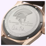 Close-up of the Hamilton Watches Khaki Field Auto The Odyssey Limited Edition H70675530, showing the helmet engraving, collaboration inscriptions, signature detail on the back, leather strap, and sleek metal case.