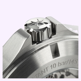 Close-up of the stainless steel crown—engraved with a star logo—on the brushed metal case of the Hamilton Watches Khaki Field King Day-Date 40mm H64475540. The crown is positioned securely between protective guards, and fine details on the watch casing are visible, emphasizing Hamilton Watches’ renowned craftsmanship.