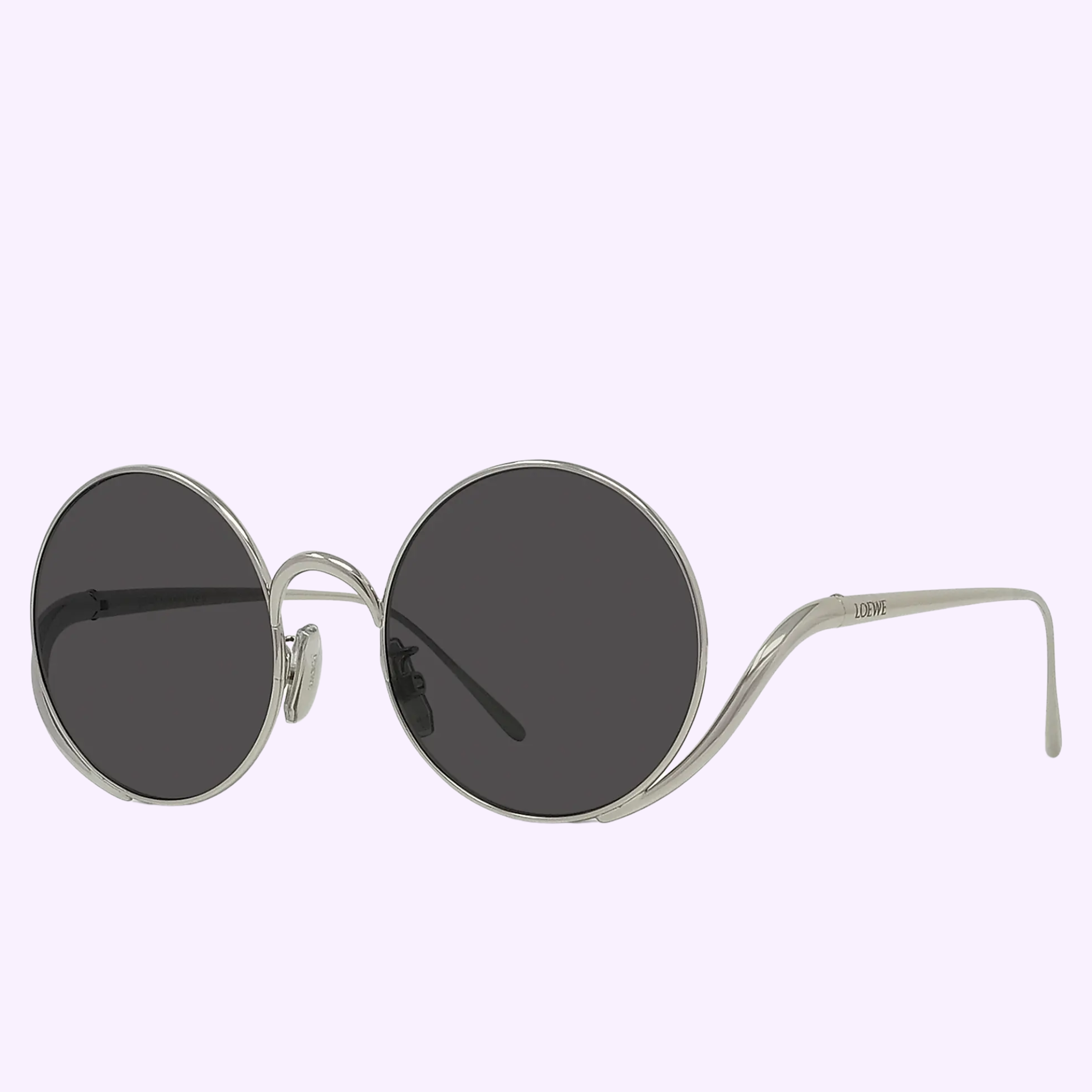 The LOEWE Sunglasses LW40187U 5016A by Loewe Sunglasses feature oversized round frames in thin silver metal with dark tinted lenses and sleek metal stitches, displayed against a light purple background.