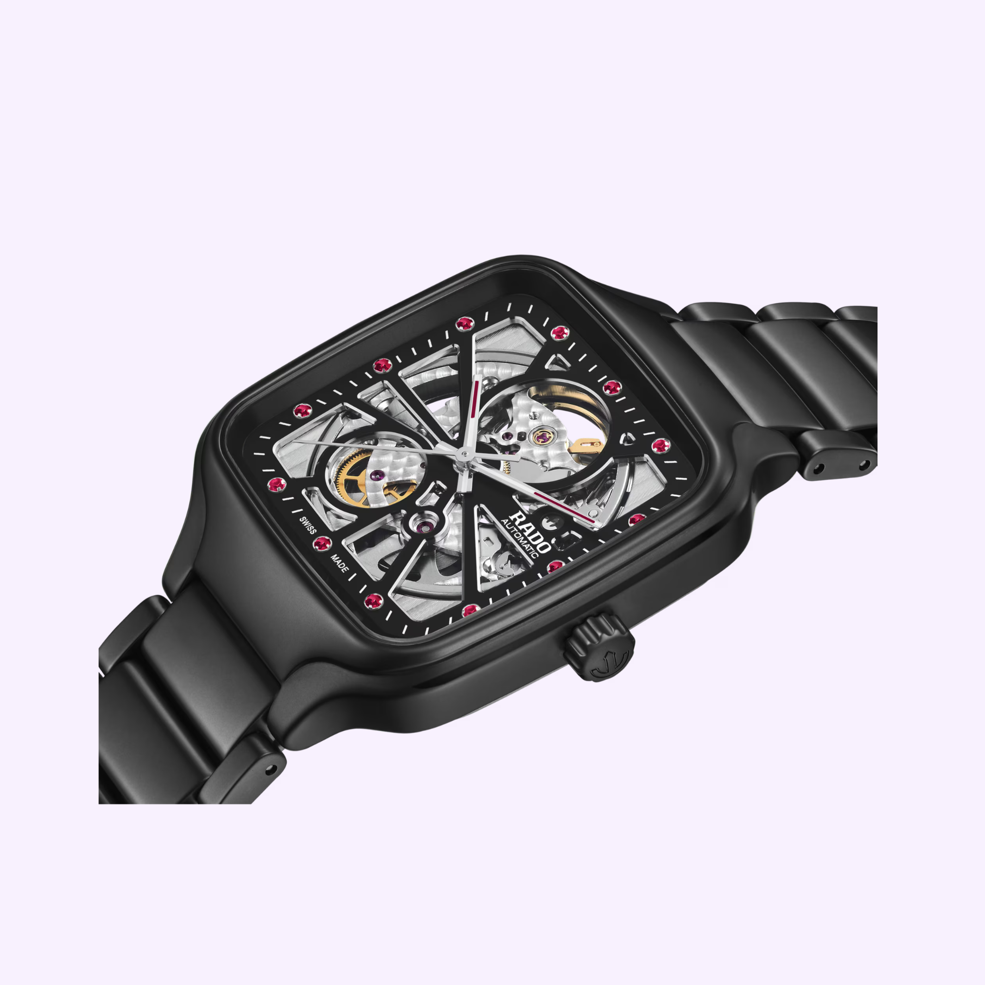 The Rado Watches True Square Open Heart X Ji Chang-wook Limited Edition R27174712 is a black rectangular wristwatch with a metal band and skeleton dial revealing its mechanical inner workings, accented by red markers, shown against a pale background.