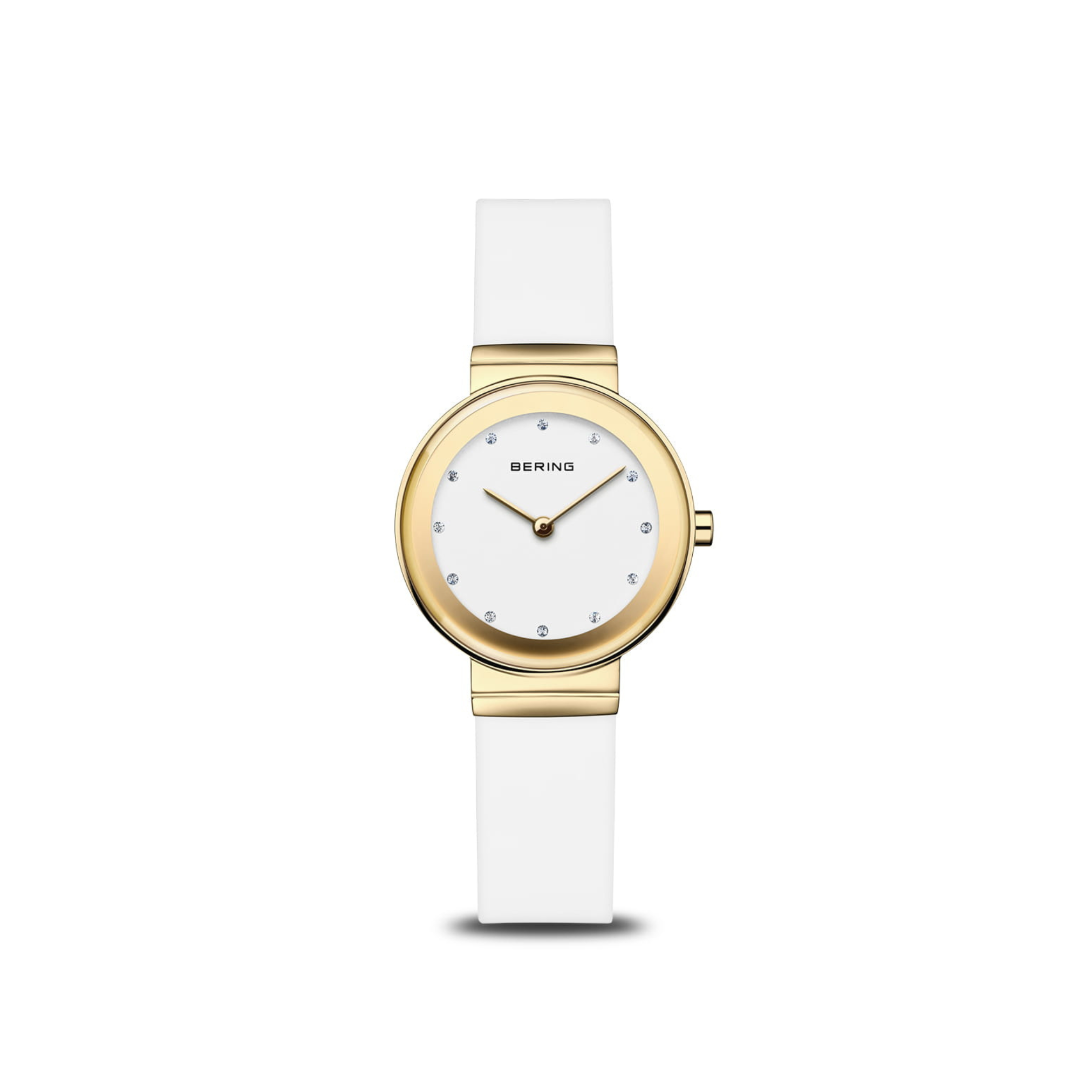 The Bering Watches Classic 10129-934 features a white strap, gold-tone stainless steel round case, white dial with crystal hour markers, and the Bering Watches logo near 12 o’clock.
