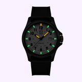 The Luminox Watches Atacama Field XL.1971.SET features a black CARBONOX case, gray dial, black numerals, luminous markers, orange 12 o’clock marker, green 3/6/9 markers, glowing white others, and a date window at 3.
