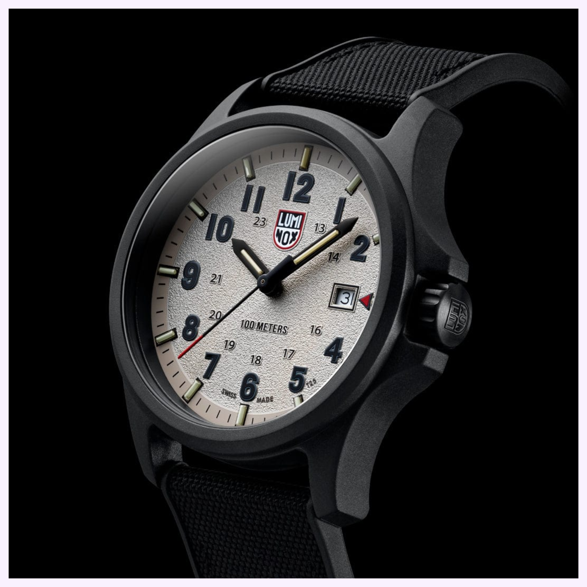 The Luminox Watches Atacama Field XL.1971.SET features a 43mm CARBONOX case, textured off-white dial with bold numerals, date window, black fabric strap, and 100m water resistance; shown at an angle against a dark background.