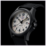 The Luminox Watches Atacama Field XL.1971.SET features a 43mm CARBONOX case, textured off-white dial with bold numerals, date window, black fabric strap, and 100m water resistance; shown at an angle against a dark background.