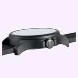 Side view of the Luminox Watches Atacama Field XL.1971.SET, featuring a CARBONOX case, round face, crown with Luminox logo, and strap detail against a light purple background.
