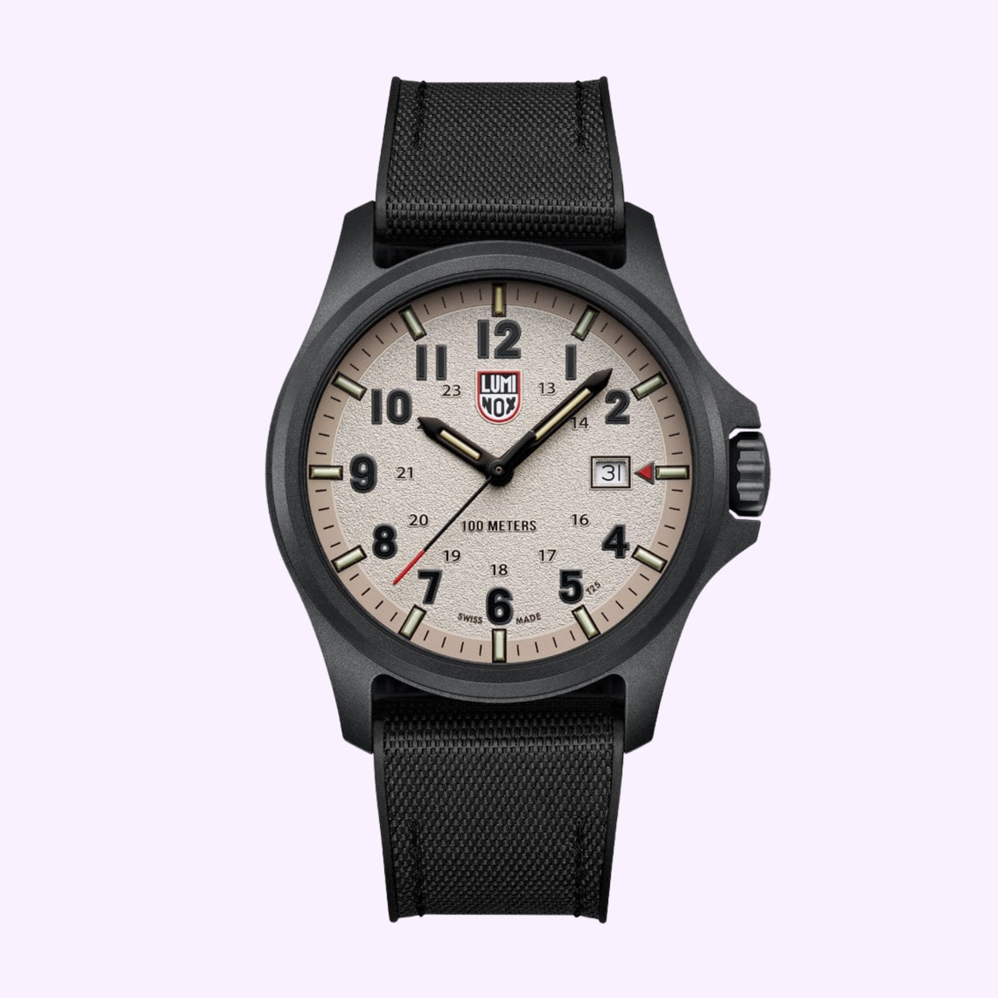 The Luminox Watches Atacama Field XL.1971.SET features a 43 mm CARBONOX case, beige dial with black numerals and hands, date window at 3 o’clock, and black textured strap, shown against a light purple background.
