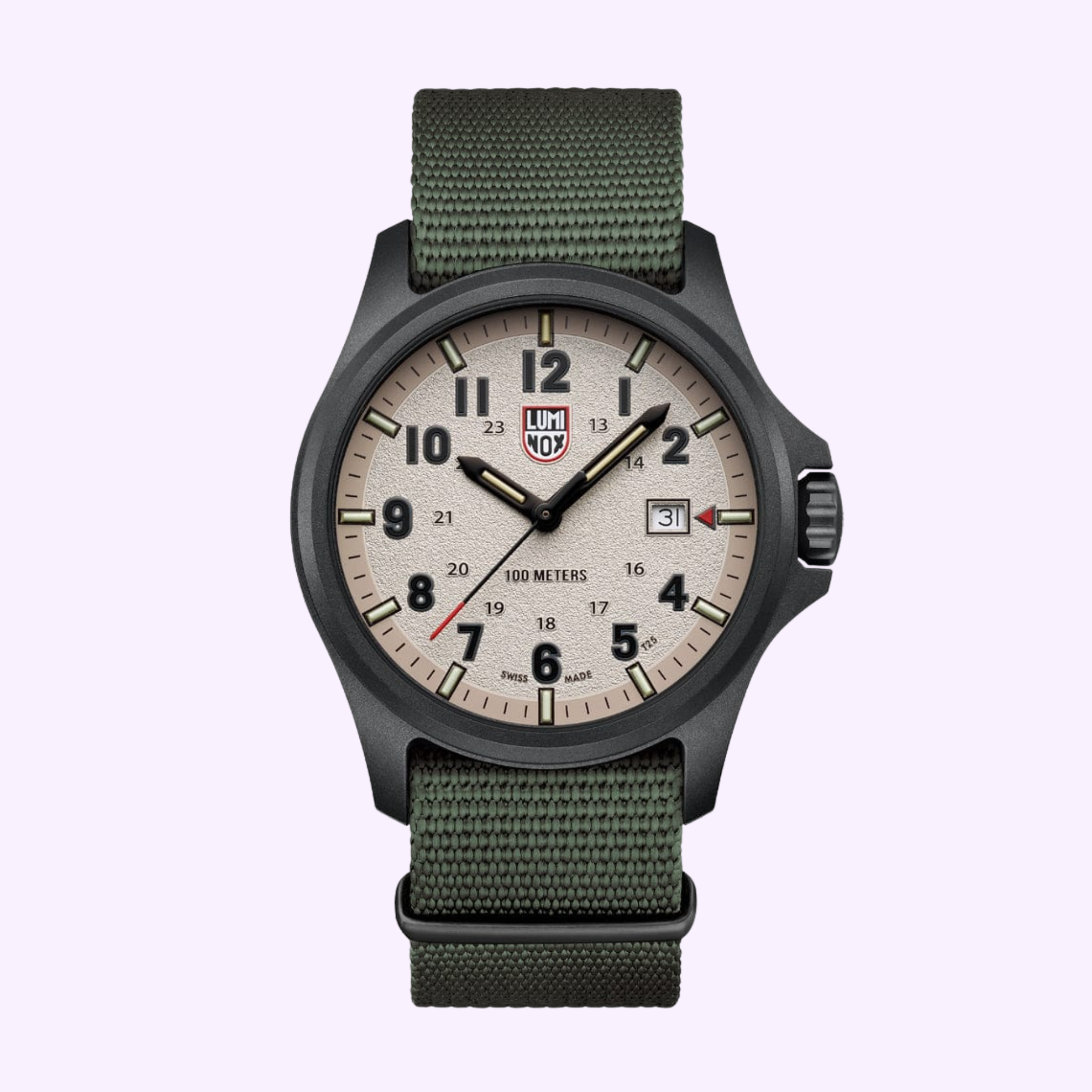 The Luminox Watches Atacama Field XL.1971.SET is a rugged 43mm field watch with a beige dial, black numerals, green fabric strap, date window at 3 o’clock, and the Luminox logo below 12, set against a light purple background.