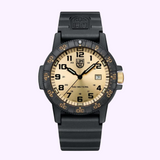 The Luminox Watches Leatherback Sea Turtle Giant XS.0325.GP (UPC: 7611382637741) features a black case, beige face with black numerals, date display, black bezel, and a durable black rubber strap on a light purple background.