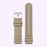 Two beige rubber straps for the Luminox Watches Leatherback Sea Turtle Giant XS.0326 are shown on a light purple surface—one has a silver buckle, while the other displays multiple adjustment holes and an embossed Luminox logo.