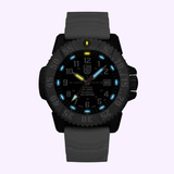 The Luminox Watches MIL-SPEC XL.3359.SET features a black case, textured strap, luminous blue hour markers, white numerals, and a yellow 12 o’clock marker. This rugged Luminox dive watch offers 300-meter water resistance.