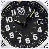 Close-up of a black Luminox Watches Navy SEAL 3500 XS.3507.WB face with white numerals, luminous-tipped hands, a date window at 31, and "SWISS MADE" at the bottom. The time displays around 1:49:38.