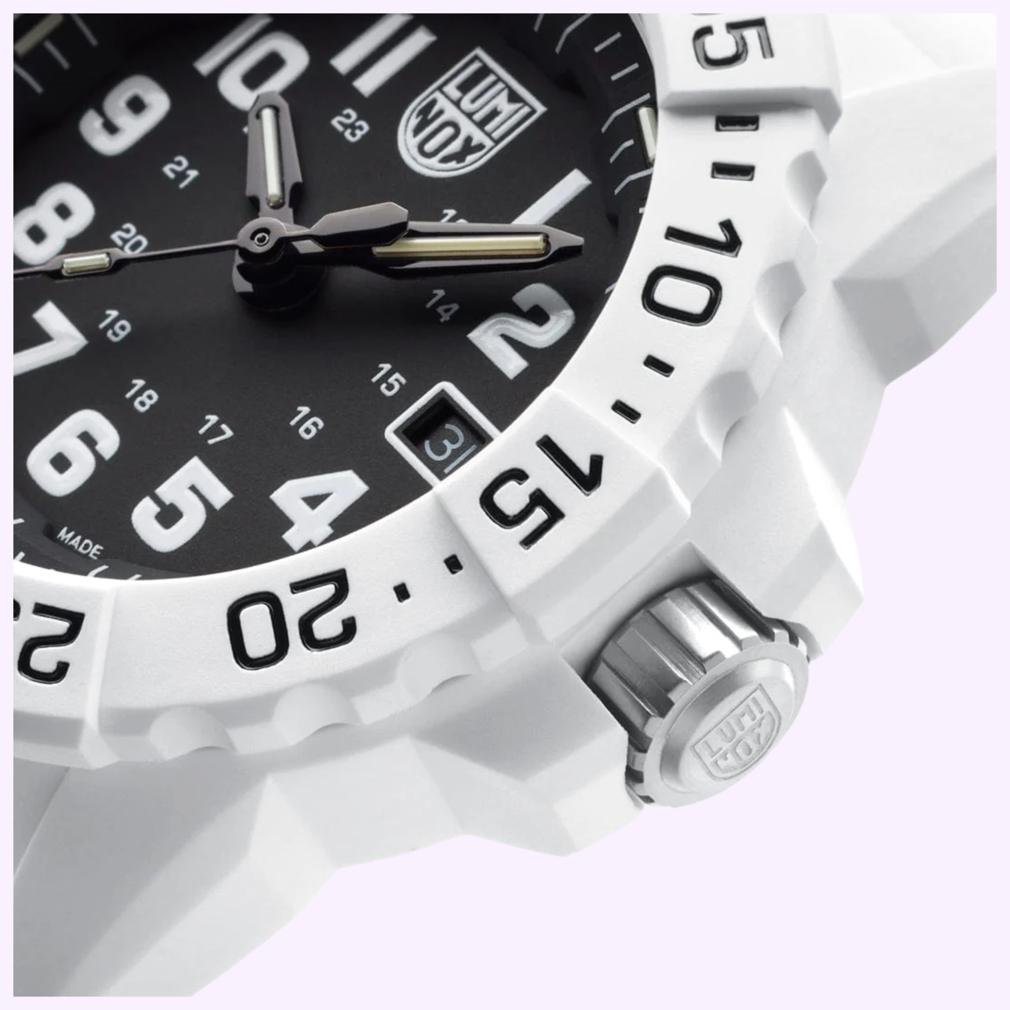 Close-up of the Luminox Watches Navy SEAL 3500 XS.3507.WB, a white timepiece with a black dial, bold white numbers, silver hands, date window at 3 o’clock, and textured bezel with minute markers and visible crown.