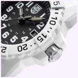 Close-up of the Luminox Watches Navy SEAL 3500 XS.3507.WB, a white timepiece with a black dial, bold white numbers, silver hands, date window at 3 o’clock, and textured bezel with minute markers and visible crown.