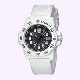 The Luminox Watches Navy SEAL 3500 XS.3507.WB features a black dial with white numerals, date display, and a textured white rubber strap—an Arctic Edition dive watch shown against a light purple background.