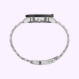 Side view of a Luminox Watches Pacific Diver Ripple XS.3123M.SET.1 with silver metal band and black bezel, shown against a light purple background. Features self-powered illumination; watch face is not visible. UPC: 7611382654717.