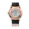The image shows the back view of the Mido Watches Baroncelli Heritage M0274073626100, featuring a rose gold PVD case, visible mechanical movement, engraved details, and a black leather strap.