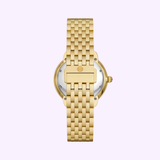 The Michele Watches SEREIN MID MWW21B000160 wristwatch (UPC: 99945535944) by MICHELE Watches is shown from the back, featuring a metal link band and a round silver case with the centered clasp, all set against a light purple background.