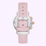 Back view of the MICHELE Watches SPORTY SPORT SAIL MWW01P000023 with a light pink leather strap, silver buckle engraved with an "M," metal clasp featuring MICHELE, and a case with elegant silver and gold detailing. Brand: Michele Watches.