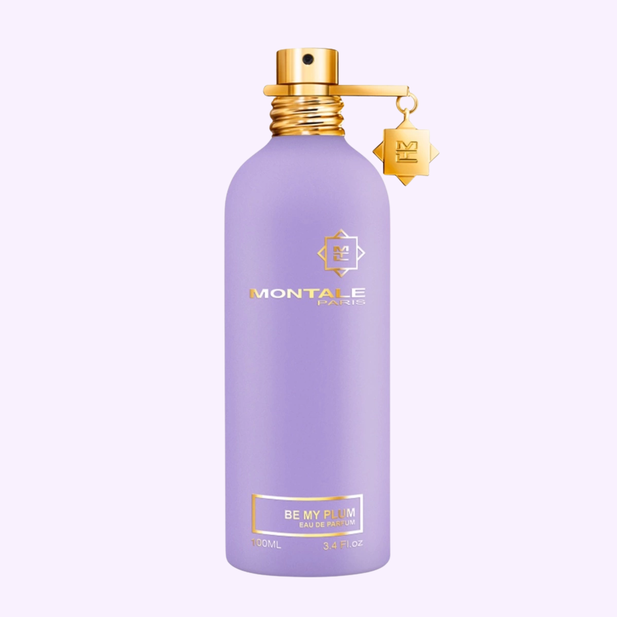 A matte lavender Montale Perfumes Be My Plum EDP 3.4 Oz bottle with a gold cap and charm sits on a light purple background—an elegant fragrance blending plum and oud.