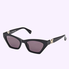 The Max Mara MM0057 5201A Women Sunglasses by Max Mara Sunglasses showcase a black cat-eye design with dark lenses and gold accents on the temples, epitomizing Italian luxury eyewear, and are beautifully presented against a light purple background.